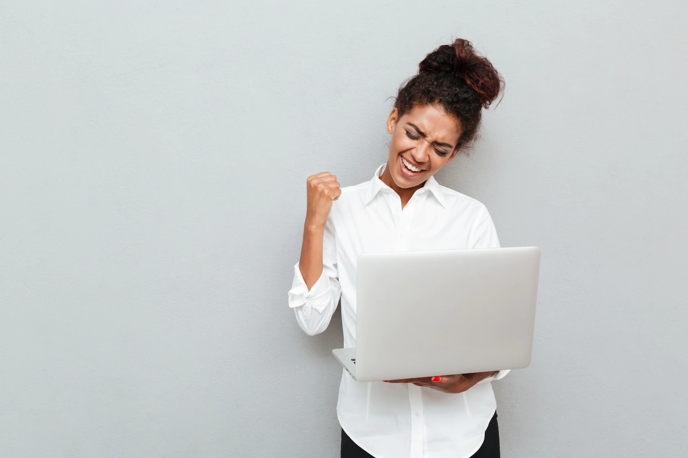 cheerful-business-woman-make-winner-gesture_171337-7371